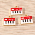Macro view of vintage enamel piano charms on wood background for DIY jewelry making - 10 Pieces Pack / Red