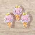 Three cute resin cartoon ice cream pendants with pink scoops and yellow bows on wood - Pink