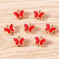 Detailed macro view of seven gold-plated butterfly charms with red enamel and hanging loops - 30 Pieces/Pack / Red Butterfly (YD1841hongse)