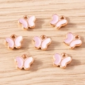 Detailed macro view of butterfly alloy charms with pink enamel and rose gold plating - 30 Pieces/Pack / Pink Butterfly (YD1841fense)