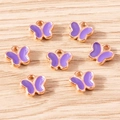 Macro detail of seven purple butterfly charms with rose gold bases on wood background - 30 Pieces / Purple Butterfly (YD1841zise)