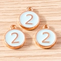 Close-up of three rose gold and light blue enamel round number 2 pendants for DIY jewelry - 10 Pieces Pack / Blue Number 2 (YD1814lanse2)