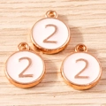 Detailed macro view of number two enamel round charms with rose gold metal finish - 10 Pieces Pack / Pink Number 2 (YD1814fense2)
