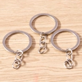 Three minimalist silver alloy keychains with rings and link chains on a wood background - 10 Pieces Pack / White K/Silver