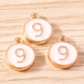 Close-up of pink round enamel number 9 alloy charms with gold plating for DIY jewelry - 10 Pieces Pack / Pink Number 9 (YD1814fense9)