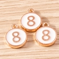 Macro shot of three rose gold number 8 charms with white enamel on a wooden surface - 10 Pieces Pack / White Number 8 (YD1814baise8)