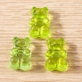 Three translucent fluorescent green resin gummy bear charms on a wooden surface - 20 Pieces Set / Green