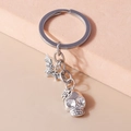 Close-up of vintage silver keychain featuring gothic bat and floral skull charms - Skeleton Head And Bat (YZ695)