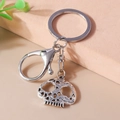 Close-up of gothic silver hollow skull keychain with lobster clasp and vintage carving - Hollow Skeleton Head (YZ696)