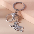 Macro shot of a vintage silver witch on broomstick charm with lobster clasp keyring - Witch On Broom (YZ697)