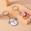 Llaveros navideños con Papá Noel y muñeco de nieve en soporte de exhibición - Juego de Papá Noel y Muñeco de Nieve