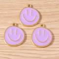 Detailed macro view of three purple enamel smiley face charms with gold metal plating - 10 Pieces Pack / Purple