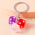 Creative keychain featuring transparent purple red and pink resin dice on a silver ring - Pink Purple