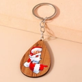 Detail of tear-drop wooden keychain featuring a colorful Santa Claus illustration - Santa Claus Style (YZ818)