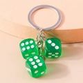 Green acrylic dice keychain featuring three transparent resin cubes with silver ring - Green