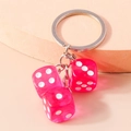 Creative pink translucent acrylic dice keychain with silver chain on warm beige stand - Rose Red