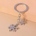 Detailed view of antique silver snowflake pendants on a creative metal keychain accessory - Double Snowflake Shape (YZ851)