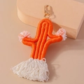 Handmade orange woven cactus keychain with soft pom-poms, white tassels, and gold hook - Orange