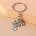 Detailed close-up of silver Christmas keychain with snowman, bells and candy cane charms - Snowman Bells And Candy Cane (YZ853)