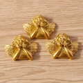 Detailed view of three golden cherub pendants with wings in a hand-on-chin pose - Hand Resting On Chin Style / 10 Pieces Pack