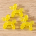 Close-up of translucent yellow resin balloon dog pendants with silver metal loops for DIY - Balloon Dog Shape (With Glitter) / 10 Pieces Pack / Yellow