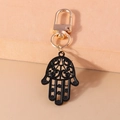 Detailed view of a black metal Hamsa Hand keychain with gold lobster clasp and ornate patterns - Hamsa Hand (YZ948)