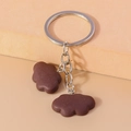 Detail of creative chocolate brown cloud-shaped resin keychain with silver metal ring - Brown