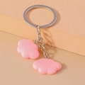 Detail of pink resin cloud charms on a metal keychain with polished silver link chains - Pink