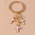 Golden keychain featuring three white enamel cross pendants in a minimalist vintage design - White