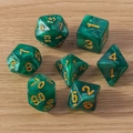Detailed view of 7 green marble polyhedral dice with gold numbers on wood background - 7-Pack Set / Green