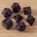 Detailed view of 7 black polyhedral DND dice with purple numbers on wood surface - 7-Pack Set / Black Rose
