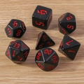 Close-up of 7-piece polyhedral dice set with black finish and red gothic numbering - Black Red