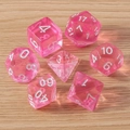 Set of 7 translucent pink polyhedral dice with white numbers on light wood background - 7-Pack Set / Transparent Pink
