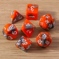 Macro shot of 7-piece orange and black marbled polyhedral resin dice set for tabletop games - 7-Pack Set / Grey Orange