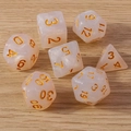 Set of 7 pearlescent pink translucent polyhedral dice with gold numbers on wood - 7-Pack Set / Transparent Yellow