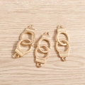 Detail of three golden handcuff pendants with Freedom engraving for DIY jewelry making - 10 Pieces Pack / Gold