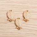 Three golden plated alloy angel wing pendants with dual hanging loops on wood background - Gold