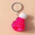 Close-up of pink knitted beanie keychain with white pompom and silver metal ring - Rose Red