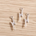 Detailed macro view of three silver lightning bolt charms for DIY jewelry making - 40Pcs Pack / Silver