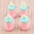 Detailed macro view of four pastel resin baby bottle charms with metal jump rings - 10 Pieces Pack / Pink