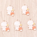 Five mummy and pumpkin Halloween alloy pendants on a light wood texture background - Mummy Pumpkin Style / 10 Pieces Pack / White