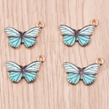 Dettaglio di ciondoli a farfalla in smalto blu con base dorata per creazione gioielli DIY - Texture Smalto Blu Lago (YD1263lvse)