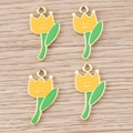 Dettaglio di ciondoli a tulipano in lega con petali gialli, foglie verdi e viso sorridente - Confezione da 10 / Giallo