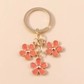 Porte-clés fleur de cerisier orange avec anneau doré et pendentifs en émail chic - Rouge