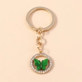 Elegante portachiavi dorato con farfalla verde e bordo con strass bianchi lucidi - Verde
