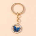 Golden keychain with blue marble acrylic butterfly and sparkling rhinestone circle pendant - Dark Blue