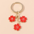 Goldener Schlüsselanhänger mit drei roten Kirschblüten-Anhängern für Handtaschen - Rot