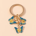 Blue and yellow gradient butterfly keychain with gold plating and enamel finish - Dark Green