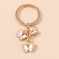 Elegante portachiavi dorato con tre ciondoli a farfalla in smalto bianco su anello - Bianco (YZ174baise)