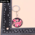 Mesure d'un porte-clés rond noir avec motifs de roses roses, pesant environ 8 grammes - Style Fleur de Rose Rose (YZ241)